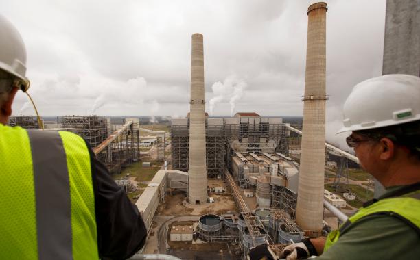 Workers at NRG’s power generating station near Houston. Credit Michael Stravato for The New York Times