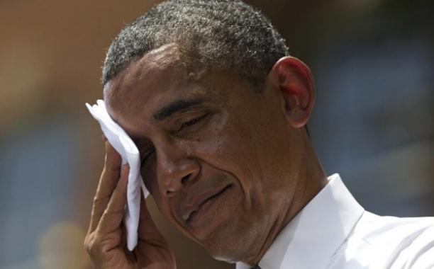 President Obama wipes sweat from his head during a speech on climate change in 2013. Obama's climate agenda is under fire from Congressional Republicans. Evan Vucci/AP/File
