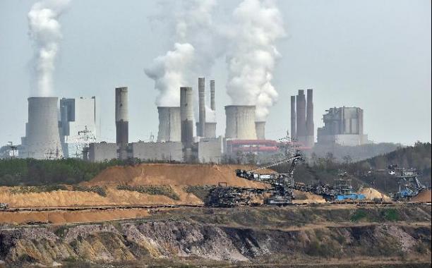 Giant machines dig for brown coal at an open-cast mining facility near the city of Grevenbroich in western Germany. (AP Photo/Martin Meissner, File)