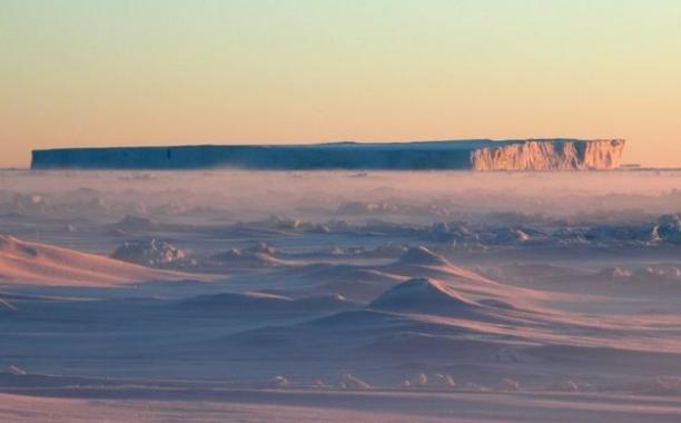 A tabular iceberg breaks away from one of the glaciers entering the Amundsen Sea.  Photo credit: M.BRANDON/OU