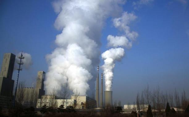 Smoke billows from the chimneys of a coal-burning power station in central Beijing March 15, 2012. Reuters/David Gray 