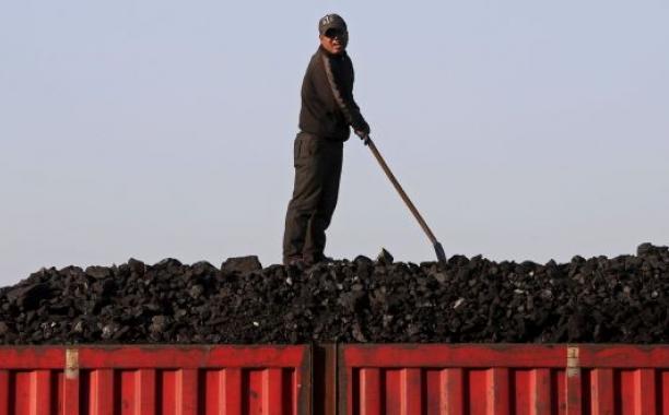 A worker unloads coal from a truck in Heilongjiang province, China. Coal-fired power plants are generally blamed as one of the chief reasons for China’s dire pollution problems. Photograph: Jason Lee/Reuters 