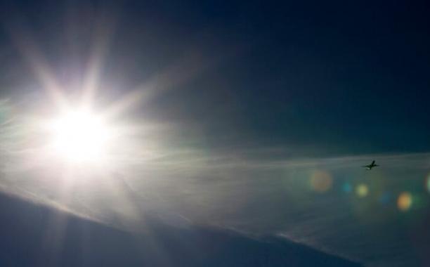 A plane flies past scatter clouds in a sunny afternoon in Beijing, China in 2011. A new study has measured an unexpected rise in emissions of the potent greenhouse gas HFC-23 in the atmosphere, even though its major producers China and India say they've drastically cut emissions. (Andy Wong/The Associated Press)