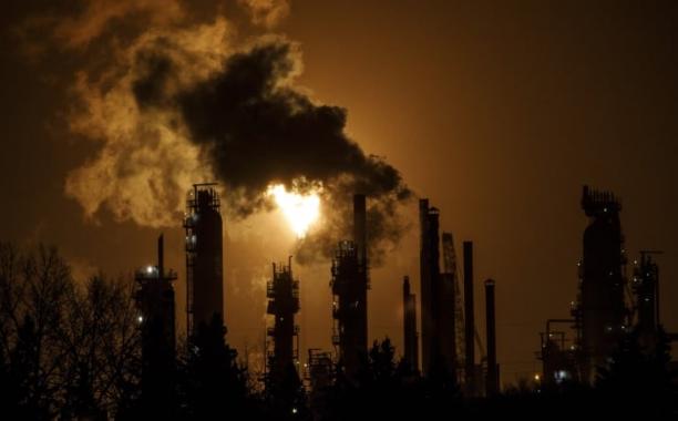 A flare stack lights the sky from the Imperial Oil refinery in Edmonton. Alberta announced $131 million investment in seven projects that are expected to cut about 2.9 million tonnes of emissions by 2030. (Jason Franson/The Canadian Press)